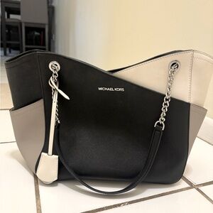 NWOT Michael Kors purse. Never used. Black, light & dark tan.